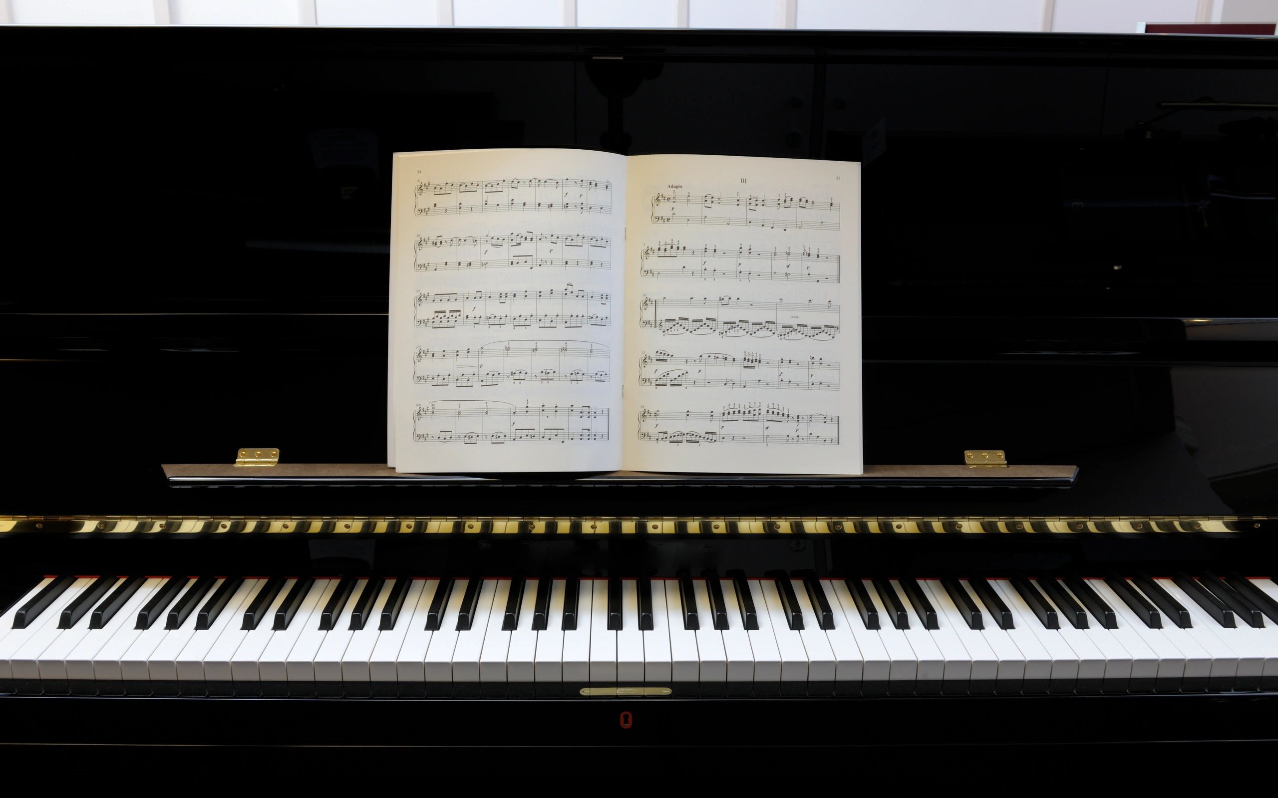 Sheet music resting on a polished piano